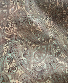 Close up of paisley turquoise chocolate paisley embossed leather hide 
