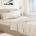 Beige christmas animal-patterned bedding in a bright bedroom.