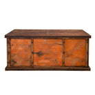 A rustic office desk with a dark brown wooden frame and three copper-paneled showing a textured, orange-toned patina, set against a plain white background.