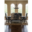 Dining room with a cowhide bench and upholstered chairs in front of large windows.