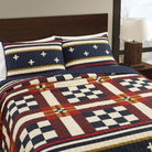 Bedding set with a geometric pattern on a bed in a bedroom setting.