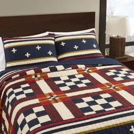 Bedding set with a geometric pattern on a bed in a bedroom setting.
