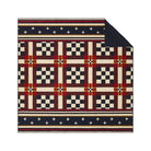 Patterned rug with geometric design on a white background