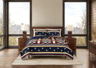 Bedroom with a bed featuring a red, white, and blue patterned comforter.