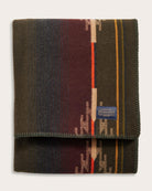 Folded Pendleton blanket with colorful pattern on a white background