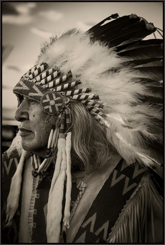 Unbroken Spirit Native American Canvas Art by Adam Mowery featuring a man in profile wearing a feathered headdress and beaded garments.
