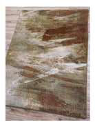 Wastelands Earth Area Rug in green, rust, and white on hardwood floor - Made in the USA