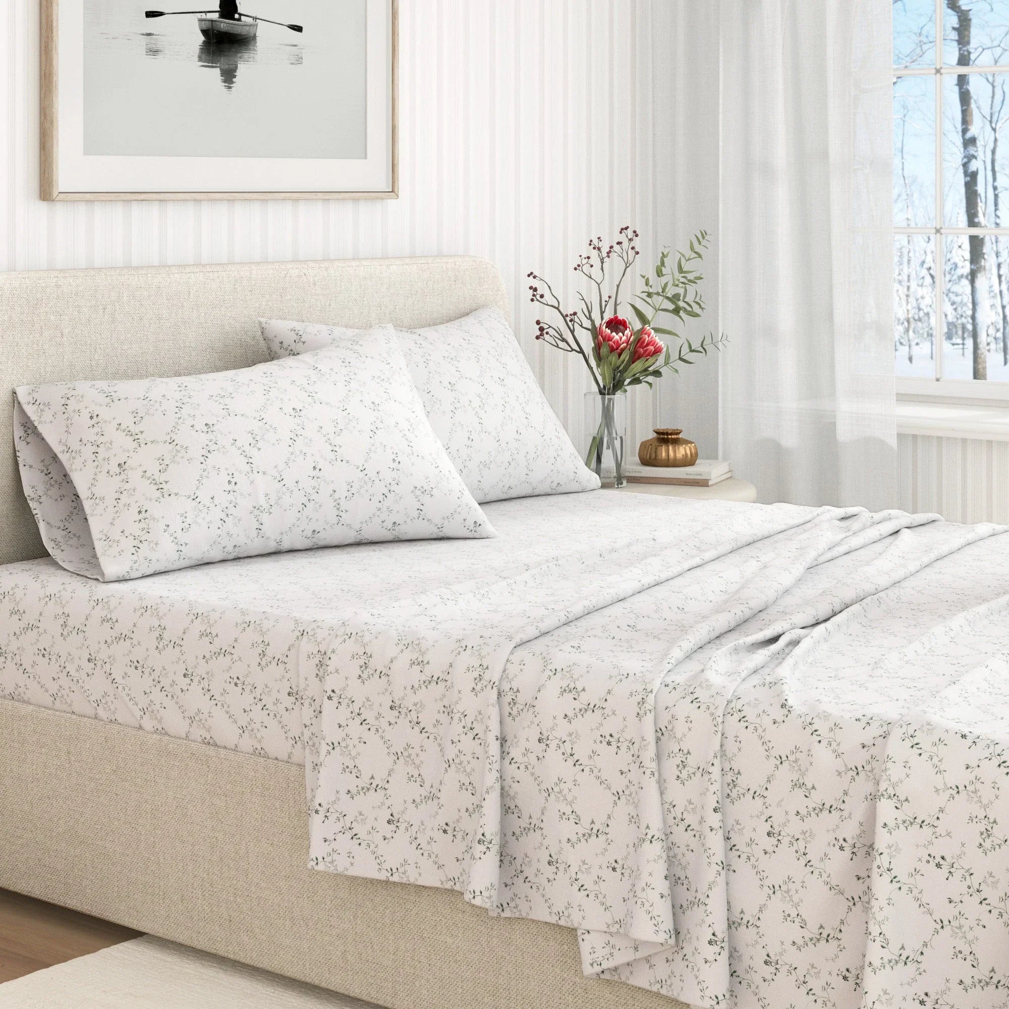 Neatly made bed with floral-patterned bedding in a bright bedroom.