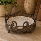 Acanthus Estate cast iron dinner plate stand holding embossed ceramic dinner plates.