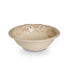Beige ceramic bowl with floral embossed patterns on a white background
