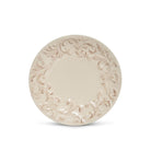 An oval ceramic appetizer plate in a warm cream or beige color, featuring a raised decorative border with a floral and scrollwork pattern, shown against a plain white background.