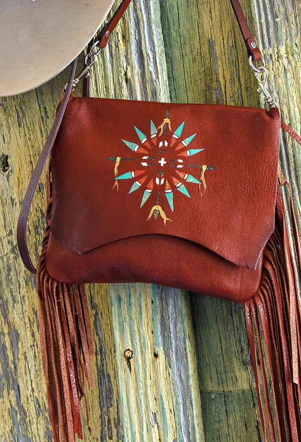 Acorn Arapaho Painted Horizon deerskin leather handbag with hand-painted motif, long fringe and crossbody strap. Shown in acorn color 