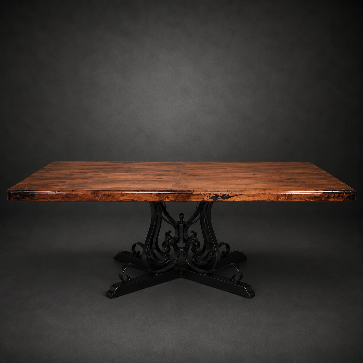 A rustic rectangular wooden dining table with a rich brown live-edge top and a black wrought-iron scrollwork pedestal base, set against a dark gray studio background.