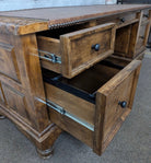 Alder wood desk with open drawers on a carpeted floor