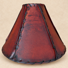 Dyed amber rawhide Cachito lamp shade with whip stitching and lacing all made by hand in Mexico 
