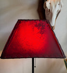 Amber rawhide lamp shade with light on 