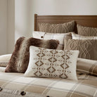 Aria patterned pillows on a bed with a wooden headboard - Your Western Decor