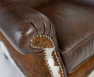 Wingback arm detail in leather, cowhide and nail trim - Your Western Decor