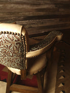 Close-up of beige leather and embossed leather barstool - Your Western Decor
