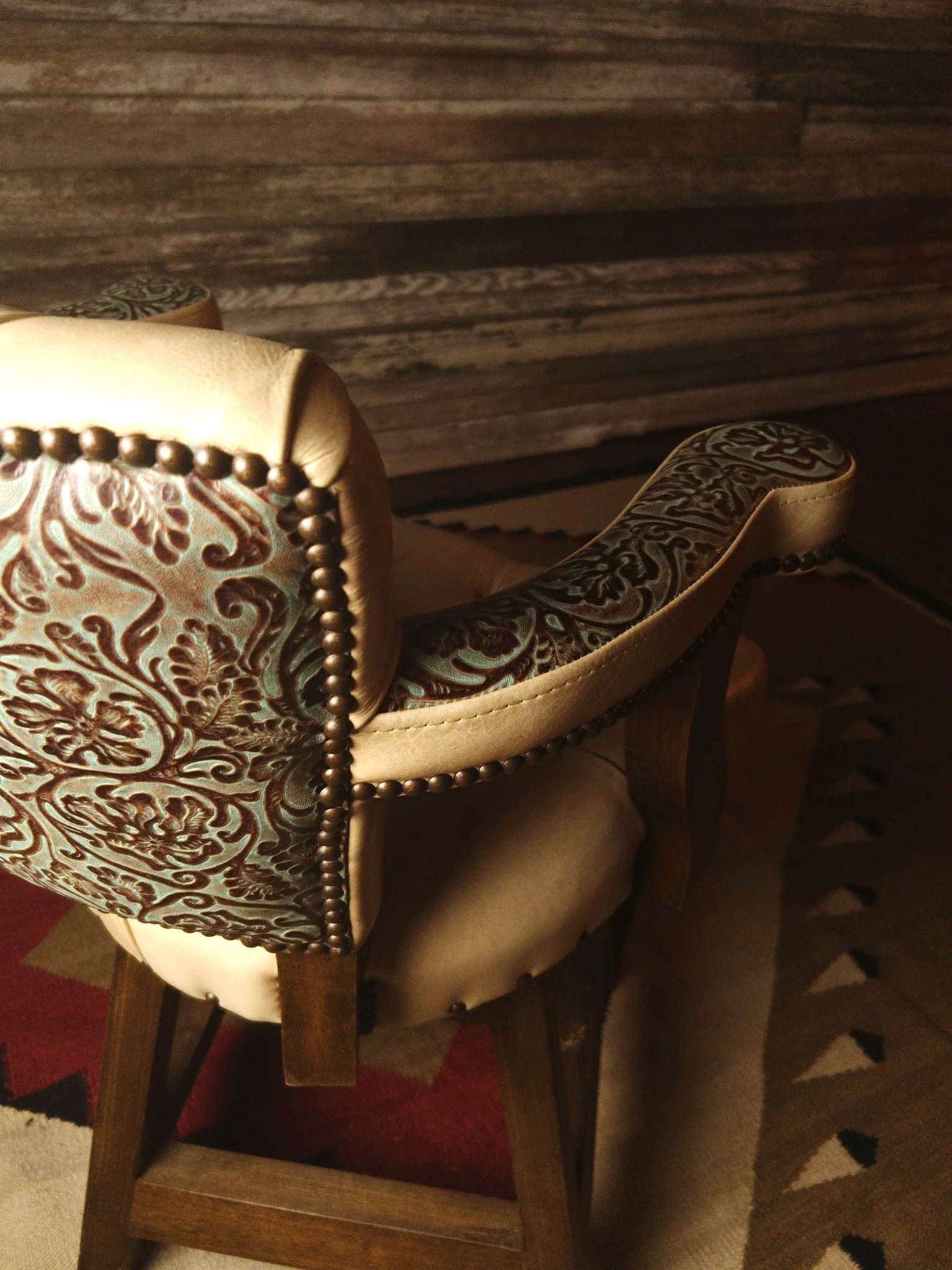 Close-up of beige leather and embossed leather barstool - Your Western Decor