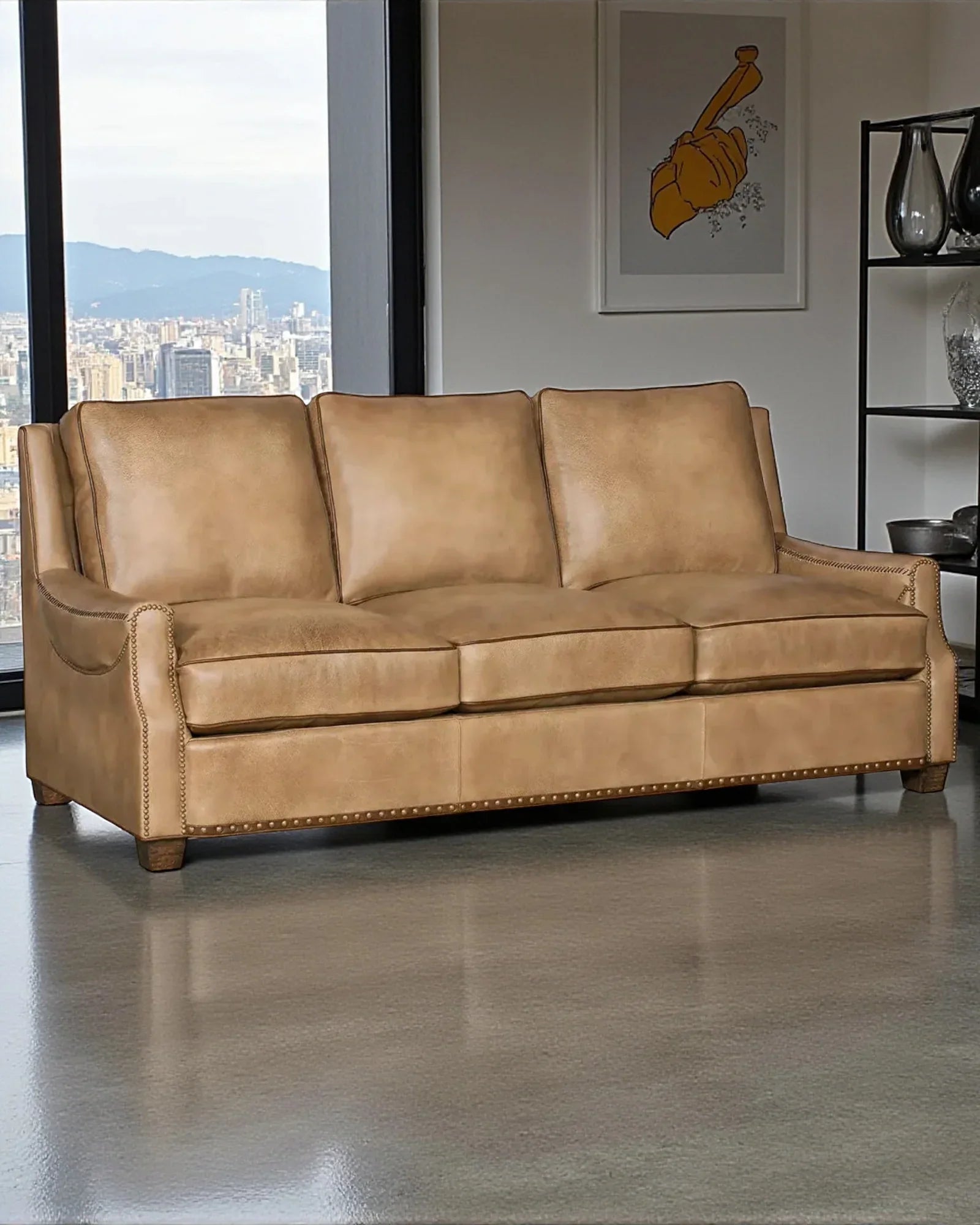 Brown leather sofa in a room with large windows and cityscape view 