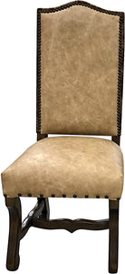 Front view of distressed beige upholstered dining chair with wood frame and nail trim 
