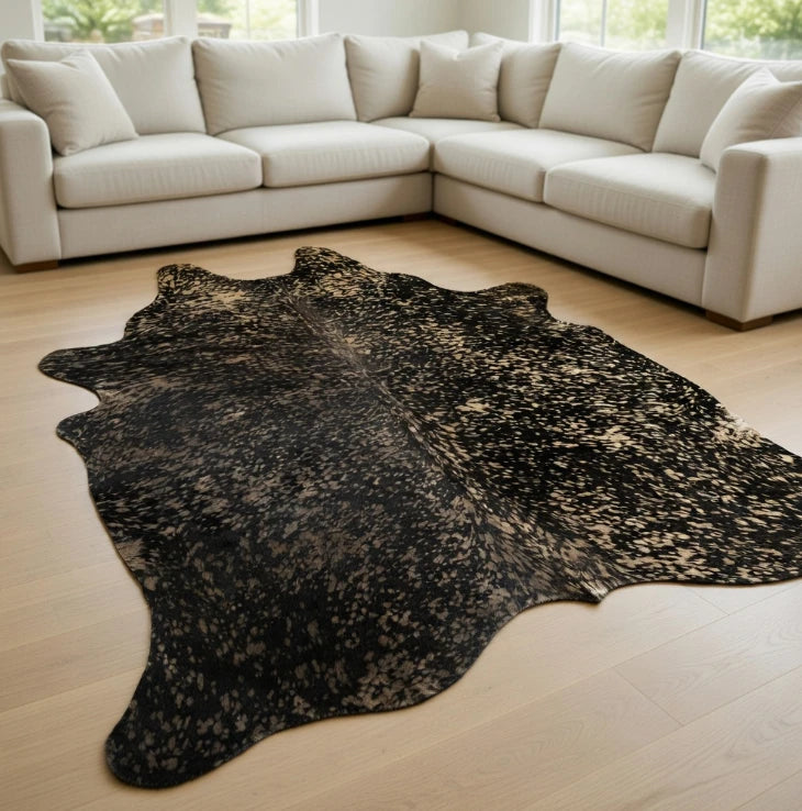 black cowhide rug with metallic gold acid wash accents in modern living room