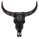 An ornate black bull skull wall decor piece with intricate silver filigree detailing on the horns and forehead, featuring a turquoise starburst inlay at the center, shown against a solid white background.