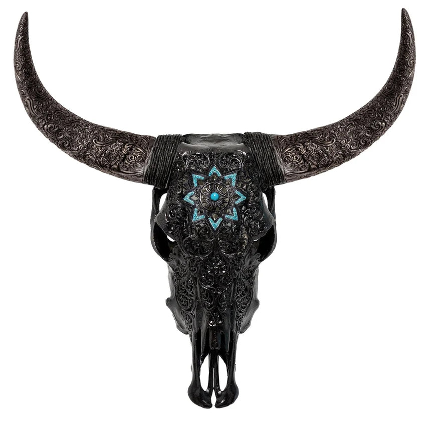 An ornate black bull skull wall decor piece with intricate silver filigree detailing on the horns and forehead, featuring a turquoise starburst inlay at the center, shown against a solid white background.