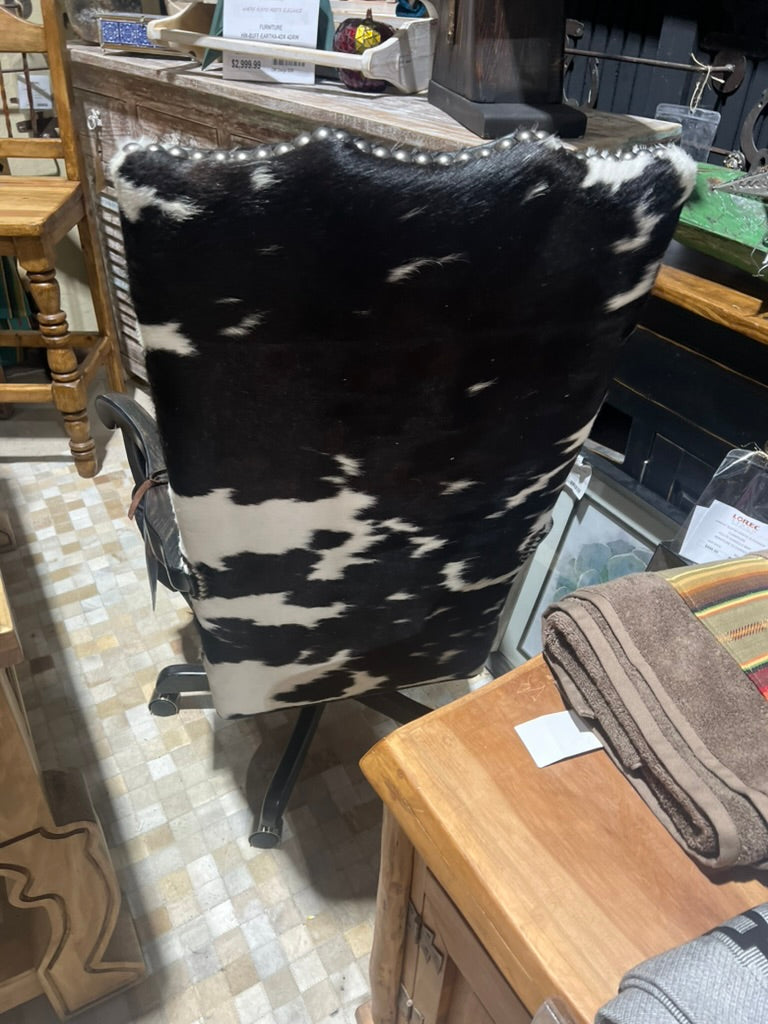 Back of black and white cowhide and black leather office chair made in the USA