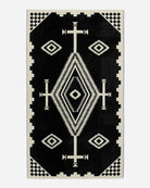 Pendleton Los Ojos Spa & Beach Towel woven from premium cotton velour featuring a bold black and ivory Southwestern-inspired pattern.