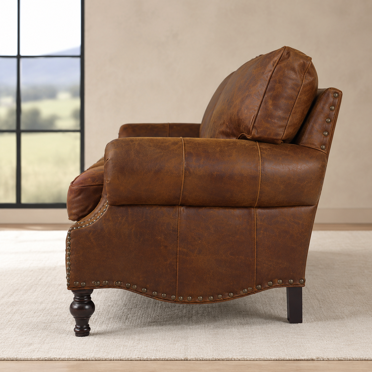 A brown distressed leather armchair shown from a side angle in a styled room setting with a window, beige wall, and light rug.