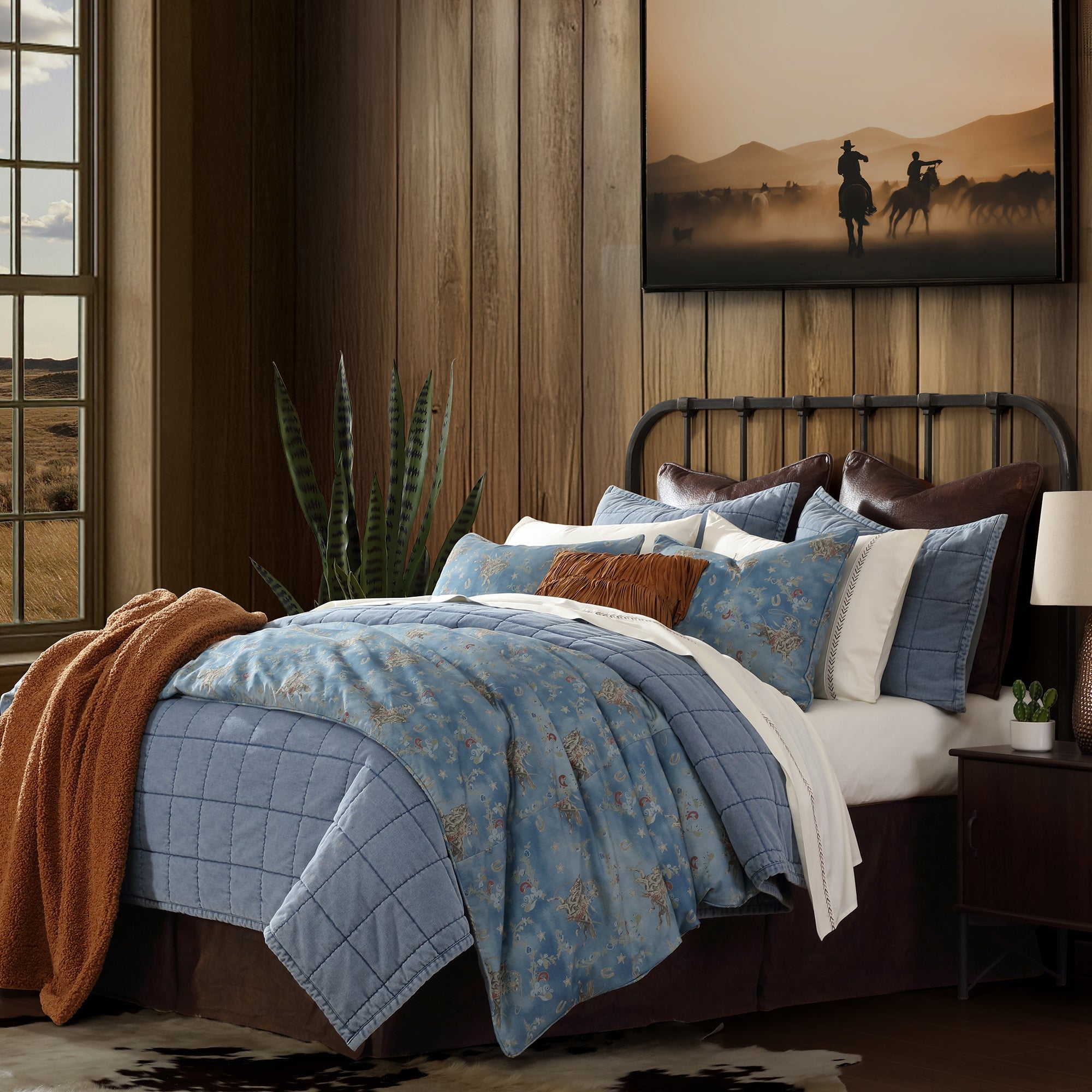 Western themed bedroom with cowboy art and blue mesa rodeo bedding set with accents