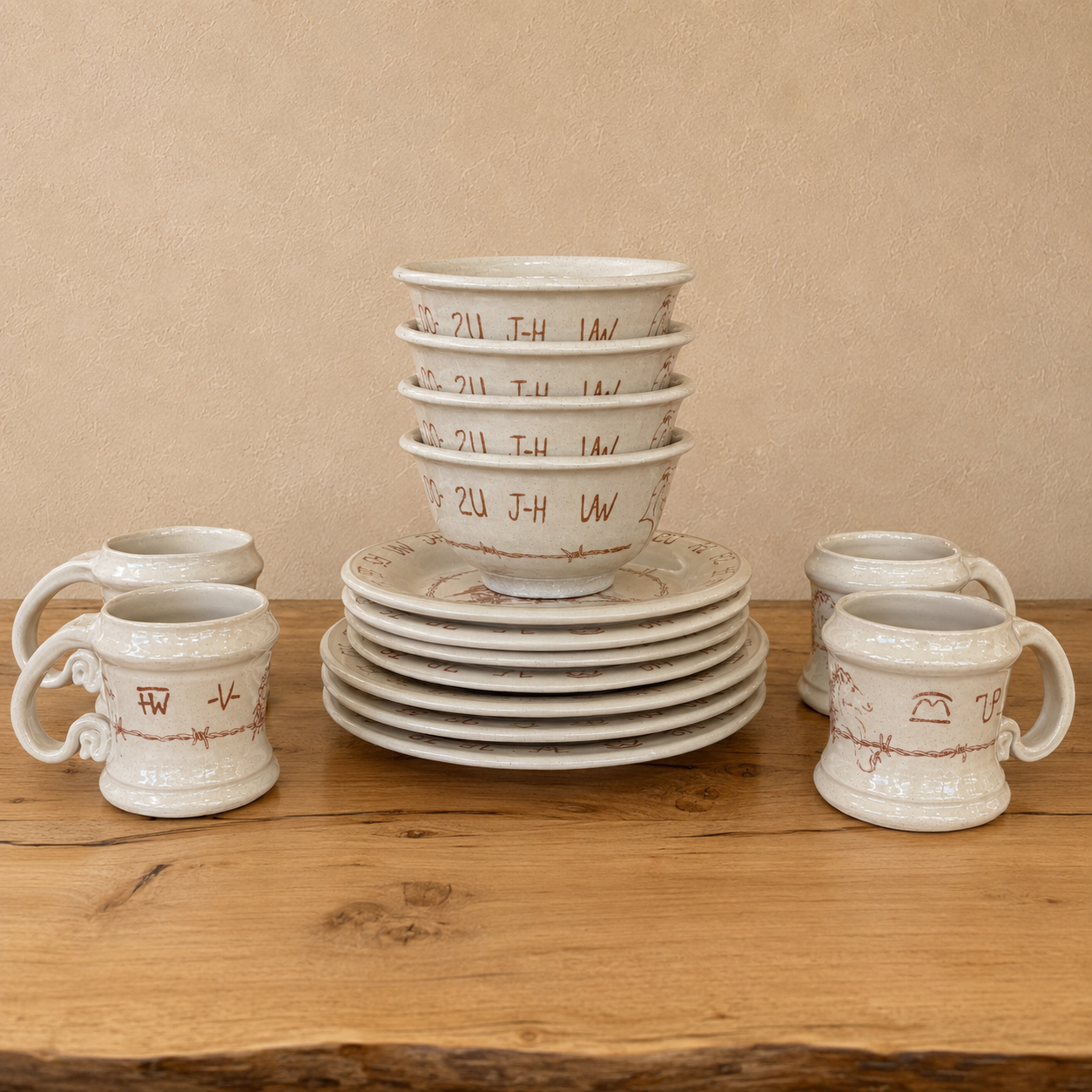 16-pc Blue Mountain Brands western dinnerware handmade in Pendleton, Oregon. Warm ivory with brown barbed wire, rodeo images and authentic Oregon ranch brands