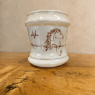 Blue Mountain Brands handmade western coffee mug featuring warm ivory base with hand drawn horse art, ranch brands, and barbed wire