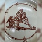 Blue Mountain Brands salad plate in warm ivory featuring a Pendleton Round Up barrel racer center with barbed wire surrounding