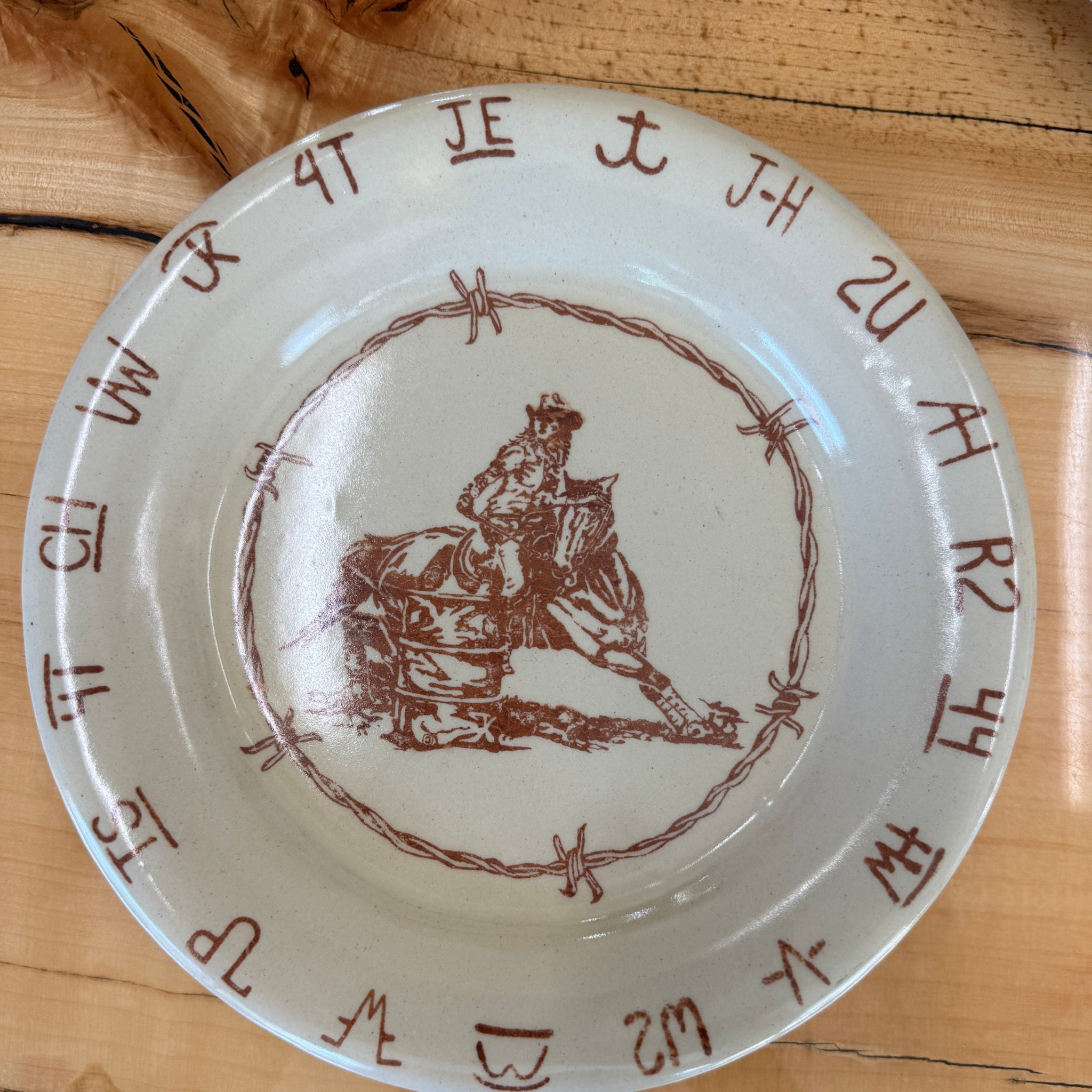 Blue Mountain Brands western salad plate handmade in Pendleton, Oregon in a warm ivory with Pendleton Round Up barrel racer, barbed wire and Umatilla County authentic ranch brands