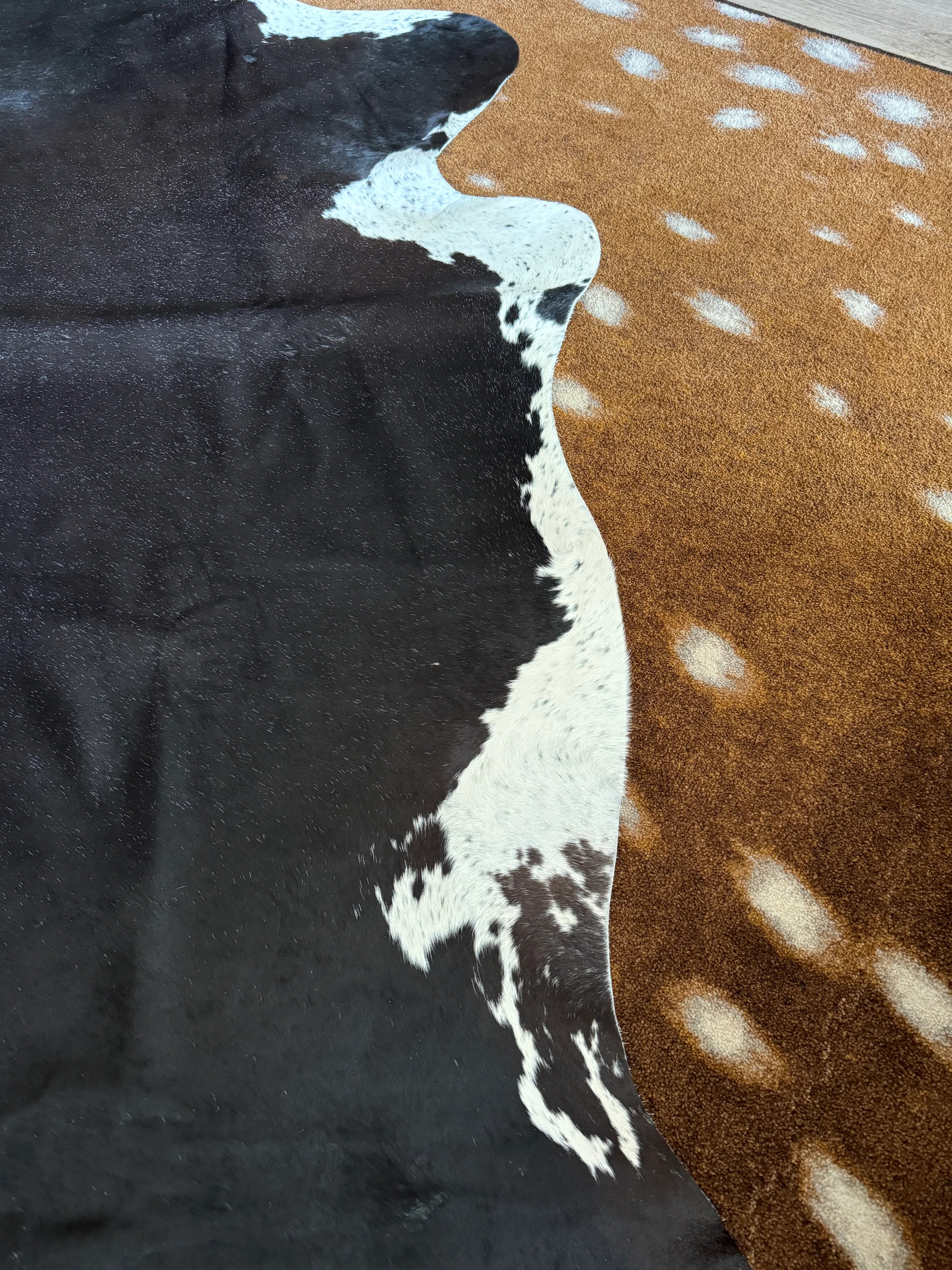 Brand on black and white cowhide rug by Saddlemans 