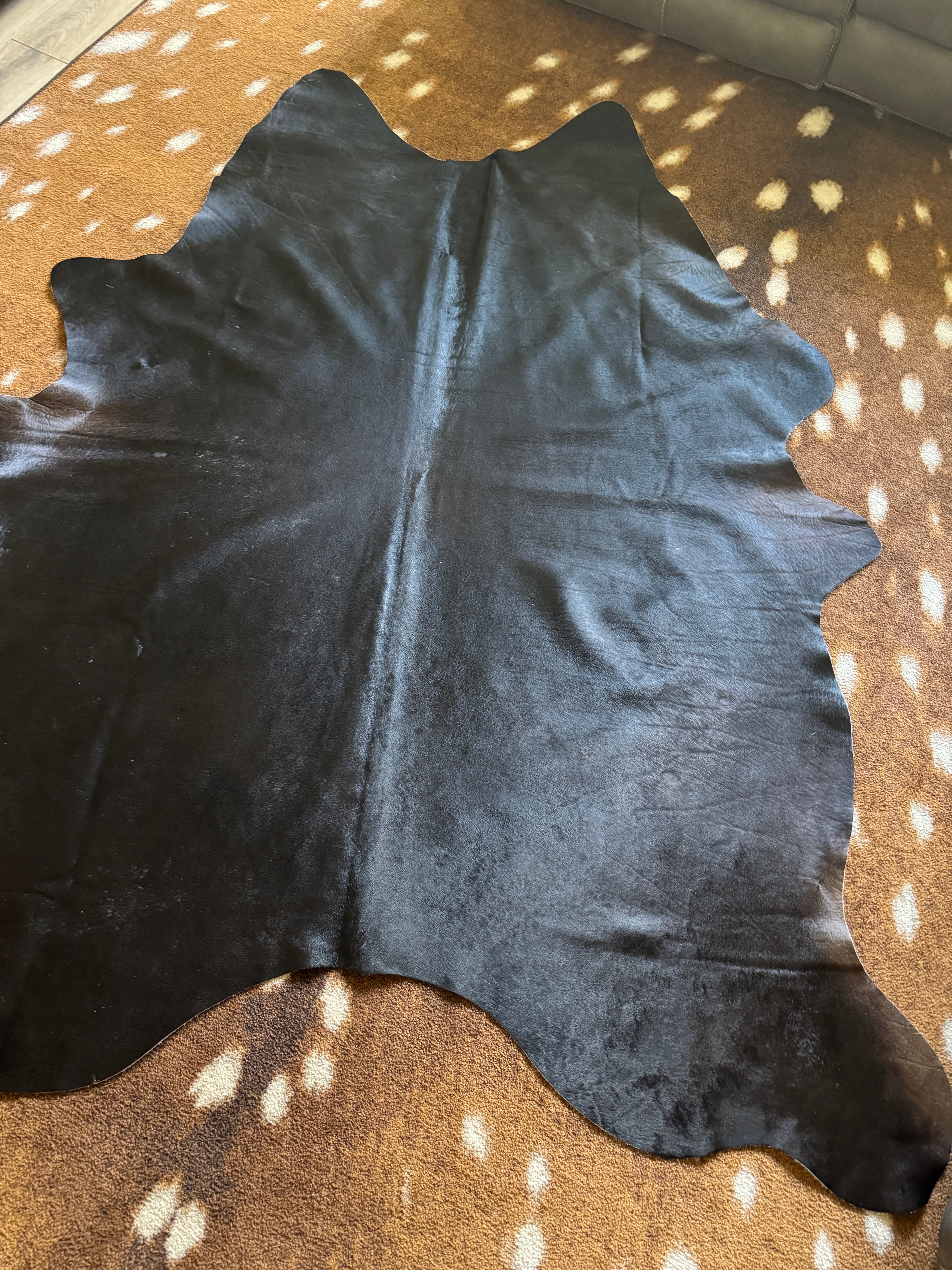 Black Brazilian cowhide rug with rich brown undertones natural hair on hide Western decor