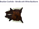 A natural cowhide rug with a dark brown and black brindle pattern and white patches, labeled 'Brazilian Cowhide - Brindle with White Backbone' on a white background.