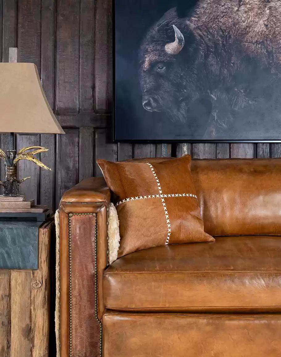 Elegant Cowhide Stitch Pillow in Brown Hide in rustic room setting - Your Western Decor