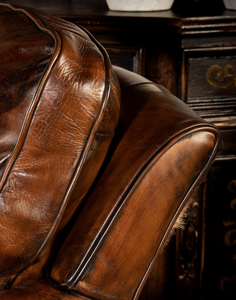 Dark brown burnished leather and brindle cowhide upholstered swivel glider chair made in the USA - Your Western Decor