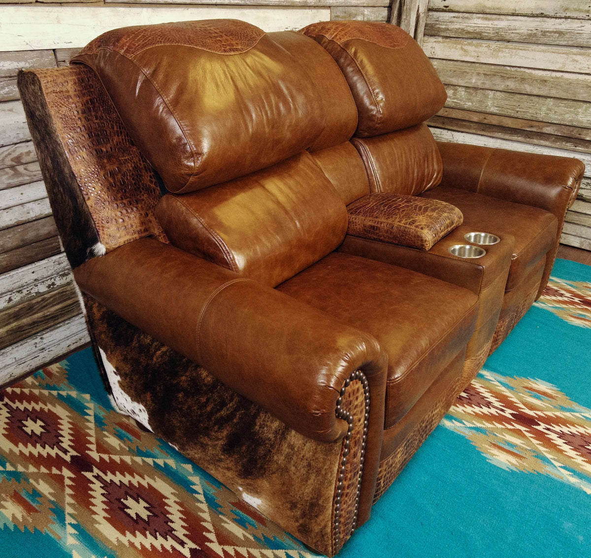 brown leather and cowhide reclining loveseat with center console 