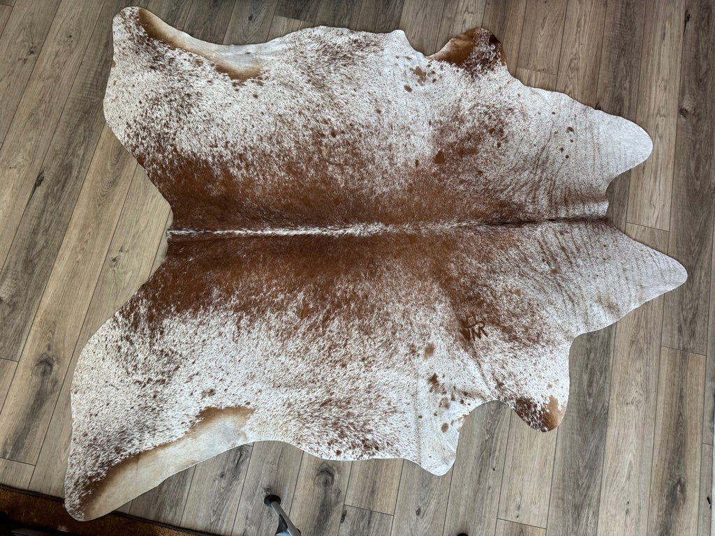 Branded brown and white cowhide rug 