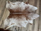 Branded brown and white cowhide rug 