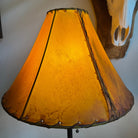 Round buckskin color rawhide 16 inch lamp shade with light on 