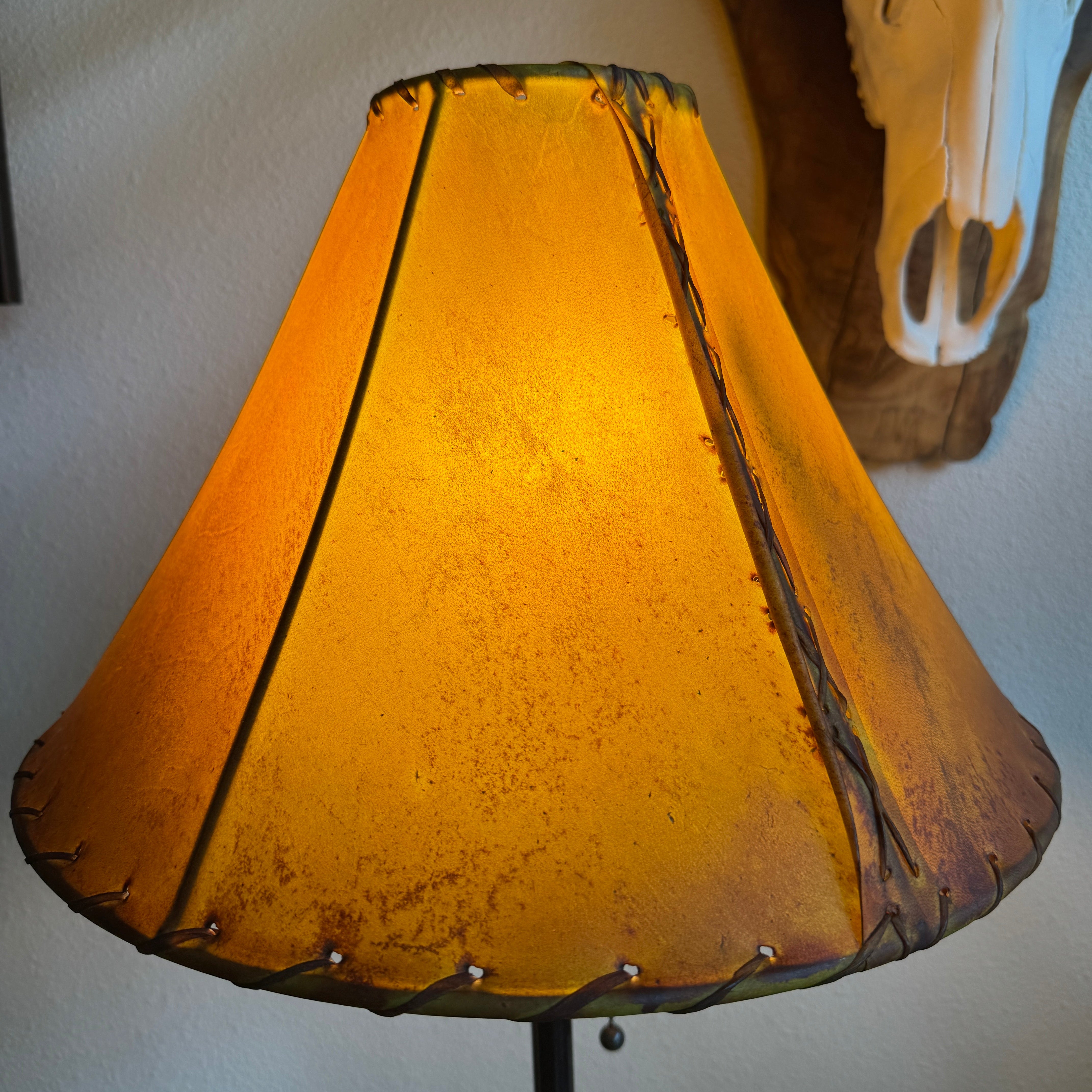 Round buckskin color rawhide 16 inch lamp shade with light on 