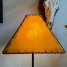 Buckskin color rawhide lamp shade with light on 
