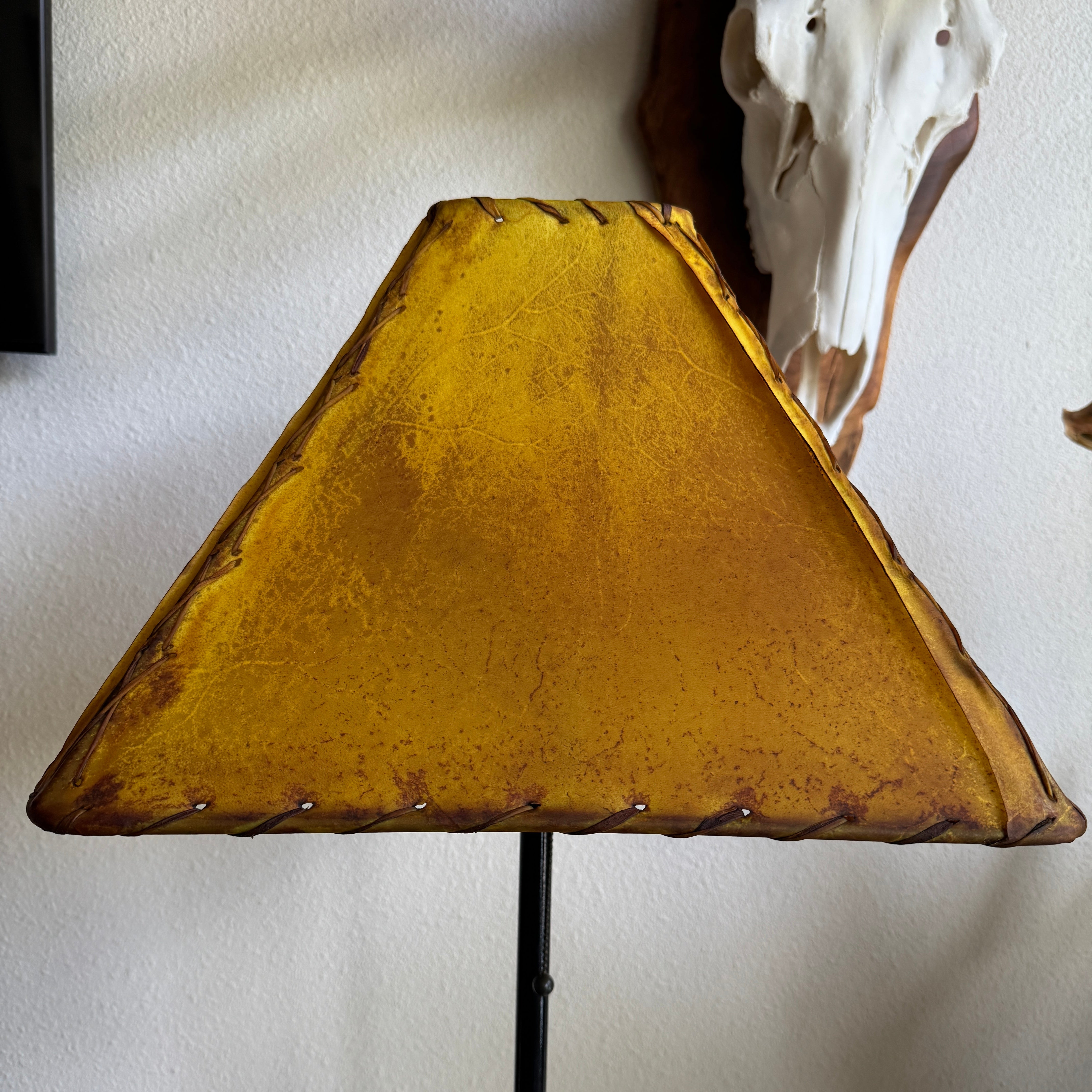 Square rawhide lamp shade in buckskin color with hand lasing and whip stitching 