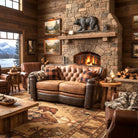 Cozy living room with stone fireplace, leather furniture, and mountain views - Buffalo Croc leather tufted loveseat - Your Western Decor